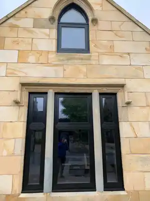 Black windows on sandstone building